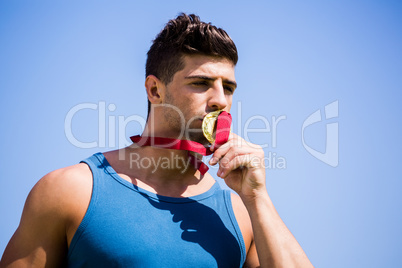 Athlete kissing his gold medal