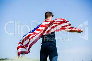 Athlete holding an american flag