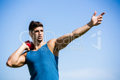 Athlete about to throw shot put ball