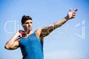 Athlete about to throw shot put ball