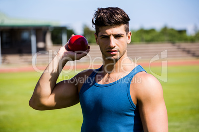 Athlete about to throw shot put ball