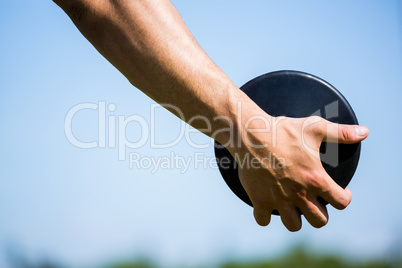 Close-up of hand holding a discus