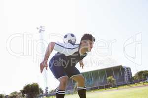 Football player practicing soccer