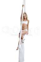 Alluring blonde dancing on aerial silks