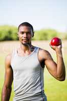 Male athlete holding shot put ball