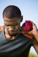 Male athlete holding shot put ball