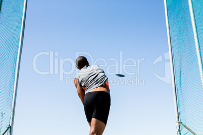 Athlete throwing discus in stadium