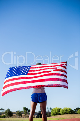 Athlete holding an american flag