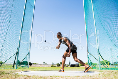 Athlete throwing discus in stadium