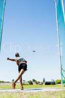 Athlete throwing discus in stadium