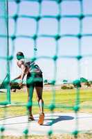 Athlete throwing discus in stadium