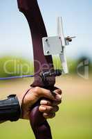 Close-up of athlete hand practicing archery
