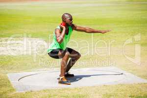 Male athlete preparing to throw shot put ball