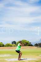 Male athlete preparing to throw shot put ball