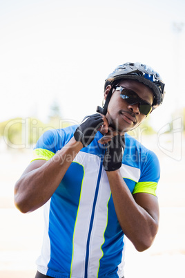 Athlete putting on cycling helmet