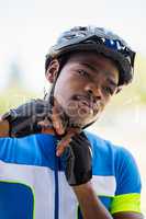 Athlete putting on cycling helmet