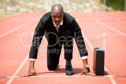 Businessman with briefcase ready to run