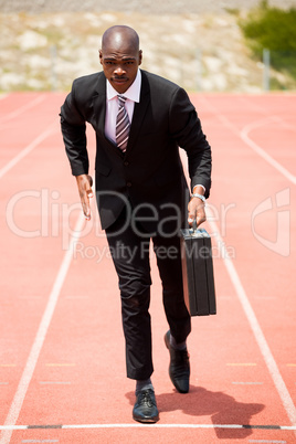 Businessman running on a running track
