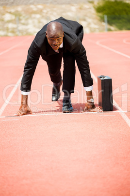 Businessman with briefcase ready to run