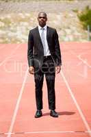 Businessman standing on a racing track