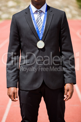 Businessman wearing gold medal