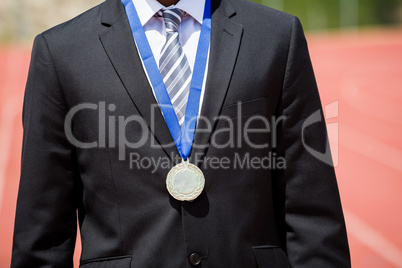 Businessman wearing gold medal