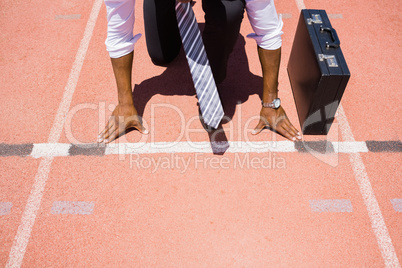 Businessman with briefcase ready to run