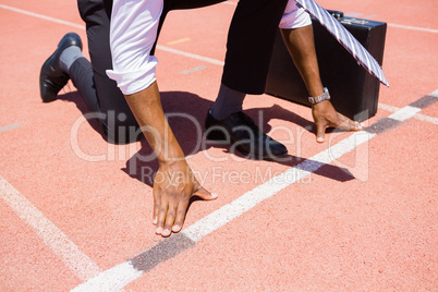 Businessman with briefcase ready to run