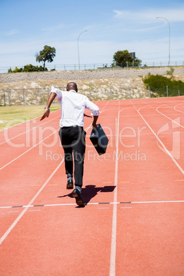 Businessman running on a running track