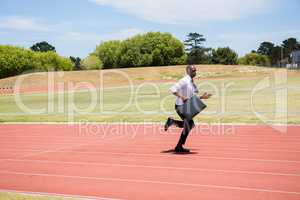 Businessman running on a running track