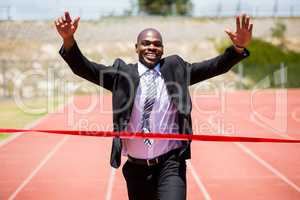 Successful businessman crossing the finishing line