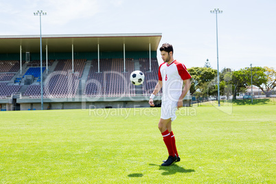 Football player juggling the football with his feet