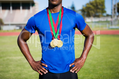 Athlete posing with gold medals after victory