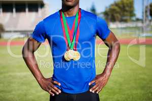 Athlete posing with gold medals after victory