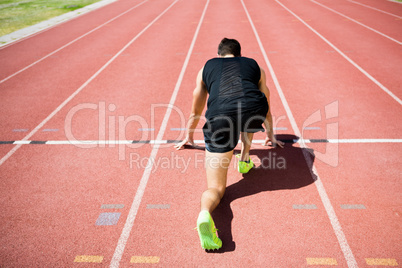 Rear view of an athlete ready to run