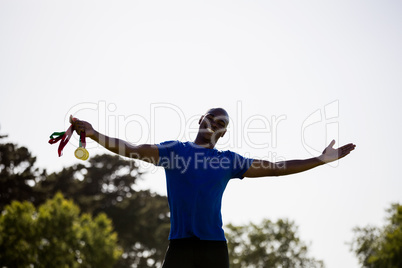 Athlete posing with gold medals after victory