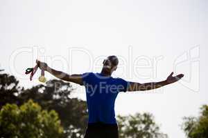 Athlete posing with gold medals after victory