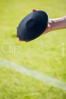 Close-up of hand holding a discus