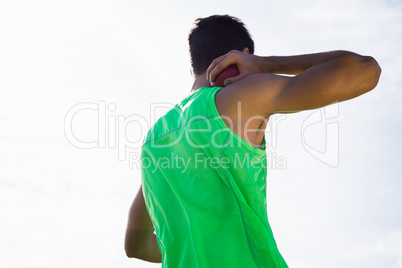 Male athlete preparing to throw shot put ball