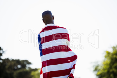 Athlete with american flag wrapped around his body