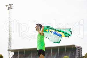 Athlete posing with brazilian flag after victory