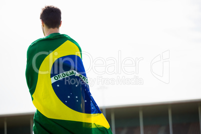 Athlete with brazilian flag wrapped around his body