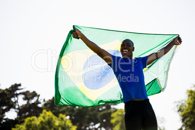 Athlete posing with brazilian flag after victory