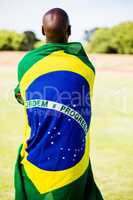 Athlete with brazilian flag wrapped around his body