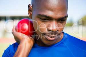 Male athlete preparing to throw shot put ball