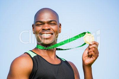 Athlete showing his gold medal