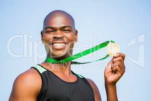 Athlete showing his gold medal