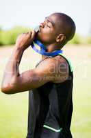 Athlete kissing his gold medal