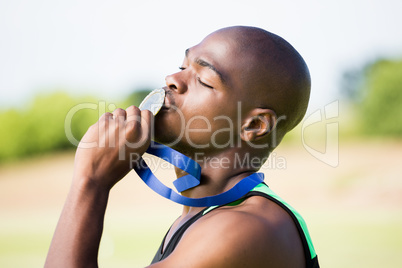 Athlete kissing his gold medal