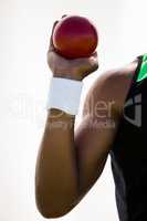 Male athlete holding shot put ball